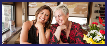 Mary and Cindi smiling at the Salon front desk