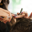 Short-haired man having his hair cut at illuminate Salon.
